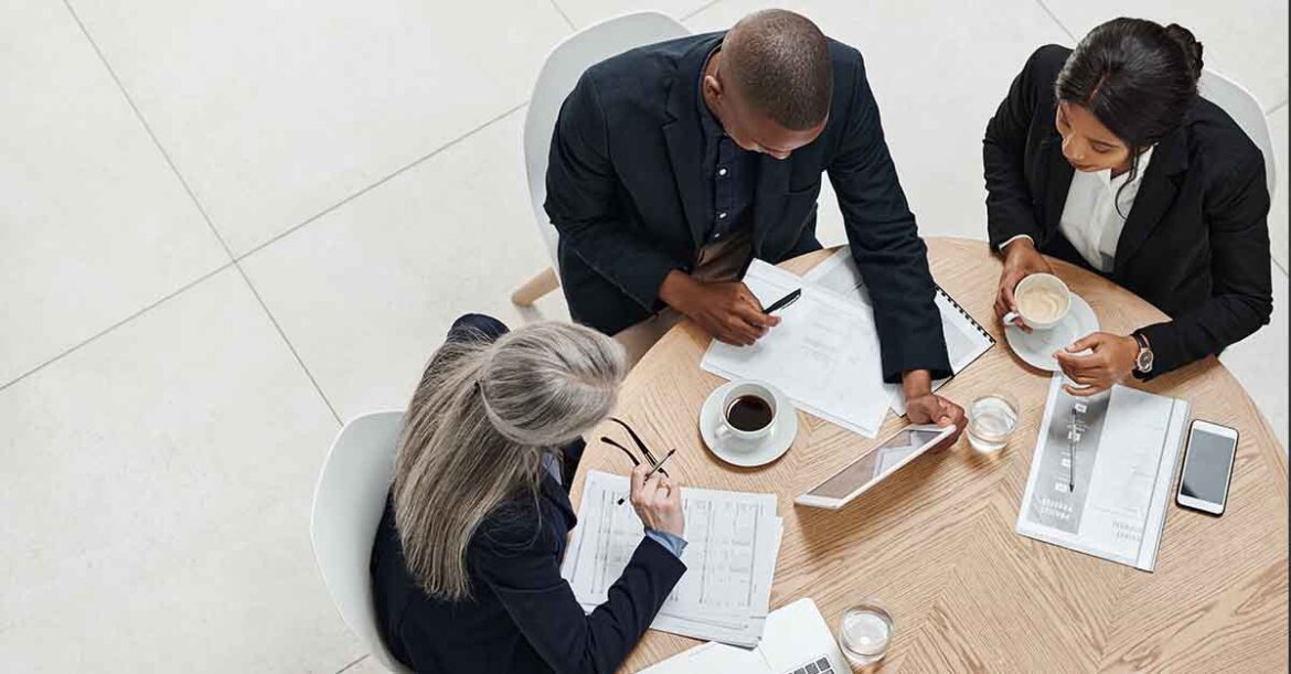 High angle shot of a group of businesspeople having a meeting in a modern office