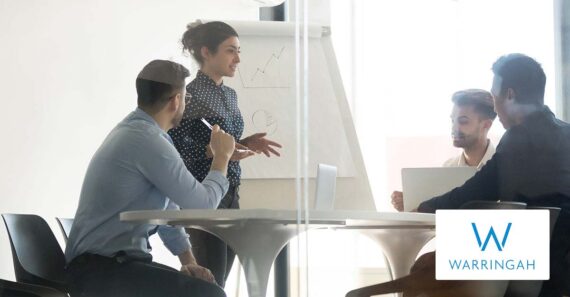 Business people listening to a young ethnic woman giving a presentation