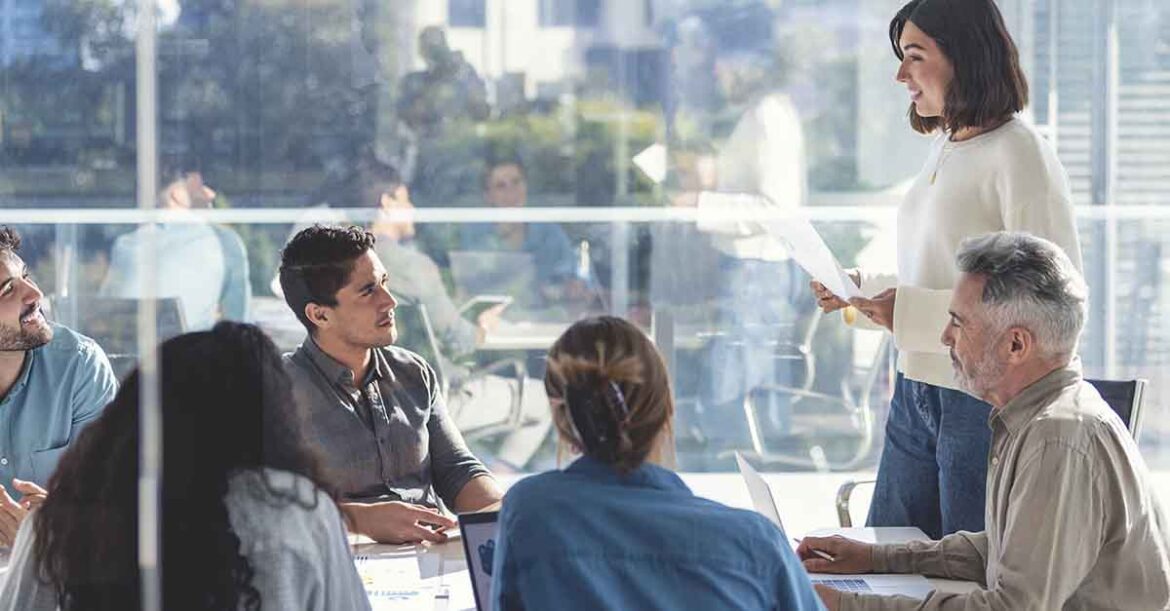 Confident woman giving a presentation with a group of people